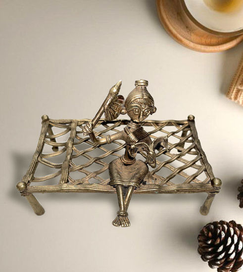 Small brass figurine of a rural lady seated on a bench, representing Indian Dhokra art and rustic home decor charm.